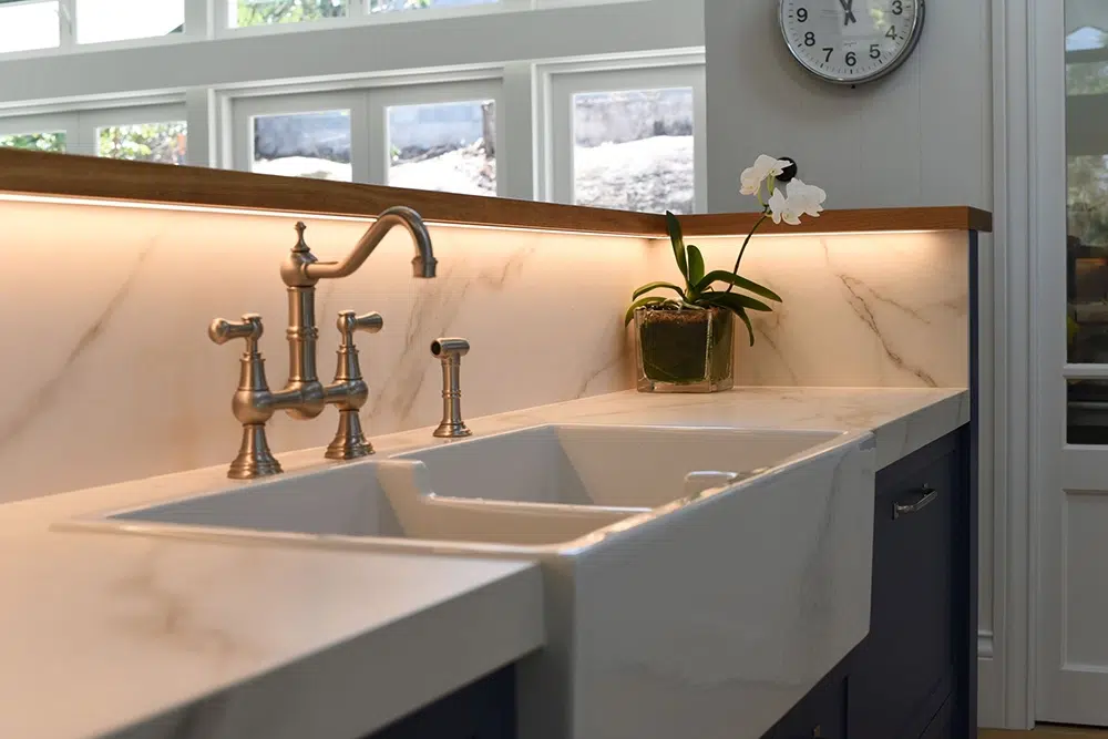 Porcelain slab splashback and benchtop behind a butler sink
